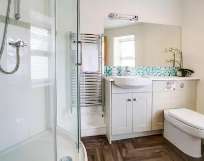 a bathroom with a shower and a sink and a toilet at The Artist Loft, Ensuite Guest Rooms, Porthleven in Porthleven