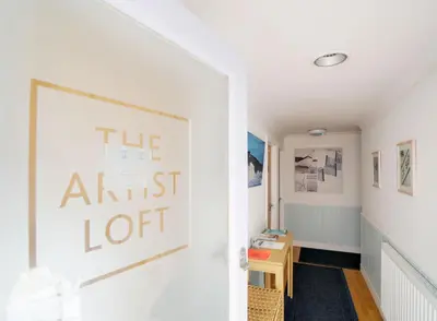 a hallway with a sign that reads theartist lot at The Artist Loft, Ensuite Guest Rooms, Porthleven in Porthleven