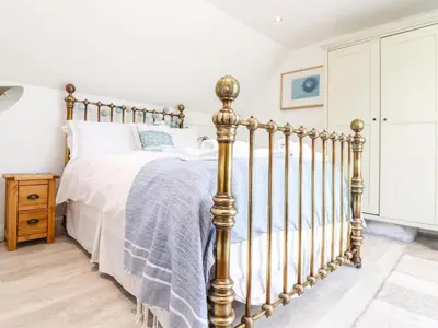 a bedroom with a bed with a metal bed frame at Penpoll in Wadebridge