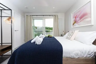 a bedroom with a large bed with towels on it at Tralee in Portreath