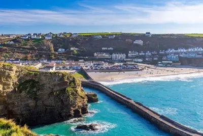 an aerial view of a beach with people on it at Tralee in Portreath