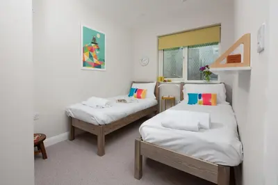 a room with two beds and a window at Tralee in Portreath