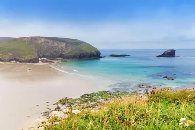 a view of a beach with rocks in the ocean at Tralee in Portreath