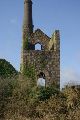 an old brick building with a chimney on a hill at Rural retreat, central location, close to beaches in Camborne