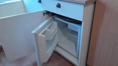 an empty refrigerator with its door open in a kitchen at Rural retreat, central location, close to beaches in Camborne