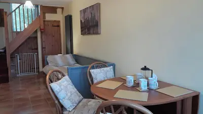 a table and chairs in a living room with a table and a table at Rural retreat, central location, close to beaches in Camborne