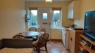 a kitchen and dining room with a table and chairs at Rural retreat, central location, close to beaches in Camborne