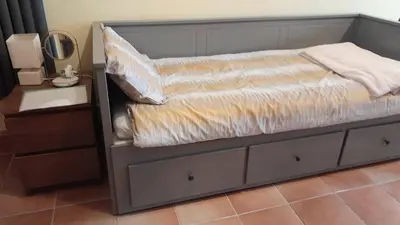 a bed with a wooden headboard and a dresser at Rural retreat, central location, close to beaches in Camborne