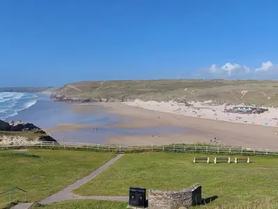 a view of a beach with people on the sand at Two bedroom cottage - country lane -10 min walk to Perranporth beach in Perranporth