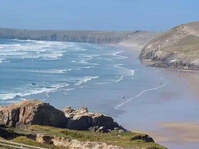 a view of the ocean and a beach at Two bedroom cottage - country lane -10 min walk to Perranporth beach in Perranporth