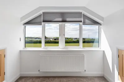 a large window in a white room with a radiator at Shackled-Am-Not - Luxury home sleeps 8 with hot tub and games room North Cornwall in Camelford