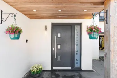 a front door of a house with two potted plants at Shackled-Am-Not - Luxury home sleeps 8 with hot tub and games room North Cornwall in Camelford