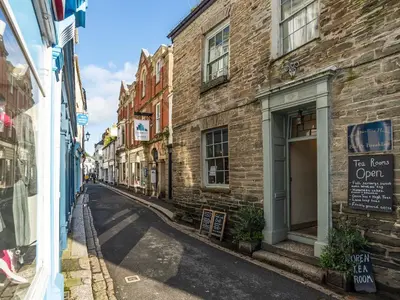 an empty street in a city with buildings at Dayan Cottage in Fowey