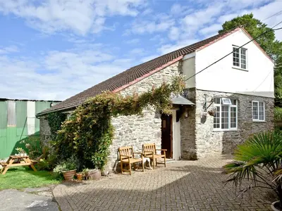 a stone cottage with a table and chairs in front of it at Stables - Uk31176 in Saint Martin