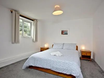 a white bedroom with a bed with two night stands at Stables - Uk31176 in Saint Martin