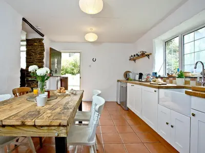 a kitchen with a wooden table and white cabinets at Stables - Uk31176 in Saint Martin