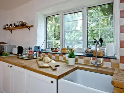 a kitchen with a sink and two windows at Stables - Uk31176 in Saint Martin