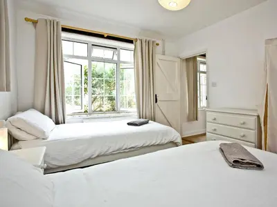 two beds in a room with a window at Granary - Uk31175 in Saint Martin