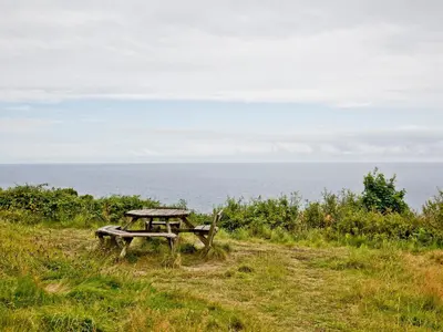 a picnic table sitting on a hill near the ocean at Granary - Uk31175 in Saint Martin
