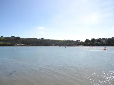 a large body of water with people in it at Honeysuckle Cottage in Cury