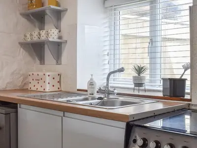 a kitchen with a sink and a window at Bee Cottage in Hayle