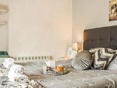 a bed with a tray of food on it at Bee Cottage in Hayle