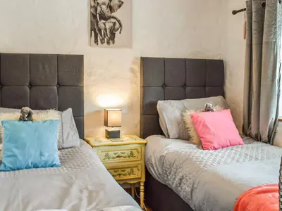 two beds sitting next to each other in a bedroom at Bee Cottage in Hayle