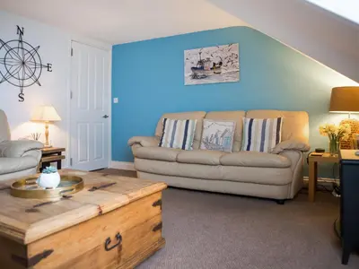 a living room with a couch and a coffee table at The Wheelhouse in Fowey