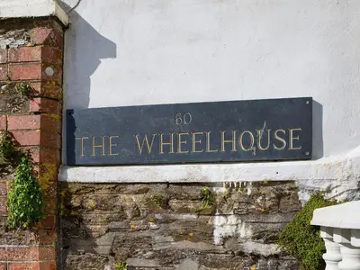 a sign on the side of a building at The Wheelhouse in Fowey