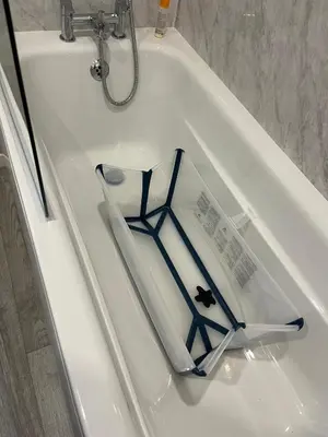 a book sitting on top of a white bath tub at Beach Base Lodge, Padstow Cornwall in Padstow