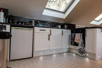 a kitchen with white cabinets and a skylight at 1 Bedroom studio with free parking in Truro