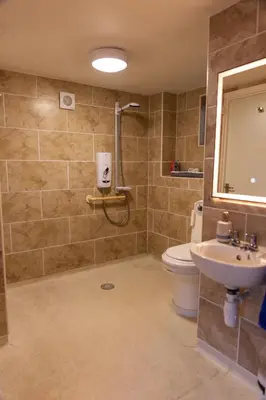 a bathroom with a shower and a toilet and a sink at 1 Bedroom studio with free parking in Truro