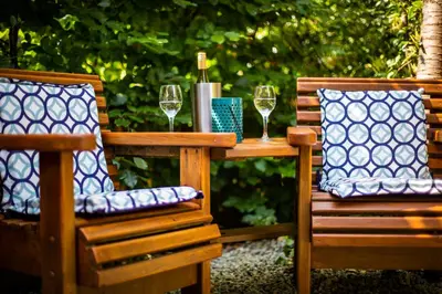 two chairs and a table with glasses of wine at 1 Bedroom studio with free parking in Truro