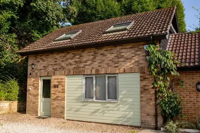 a small garage with a brown roof at 1 Bedroom studio with free parking in Truro
