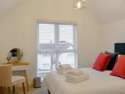 a bedroom with a bed with towels on it at Little Trevose in Padstow