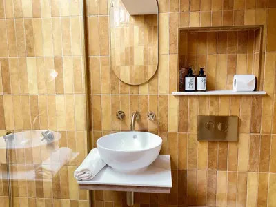 a bathroom with a sink and a shower at Luxury bolthole in central St.Agnes with parking. in St. Agnes