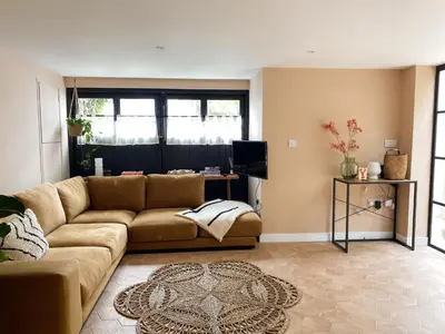 a living room with a couch and a television at Luxury bolthole in central St.Agnes with parking. in St. Agnes