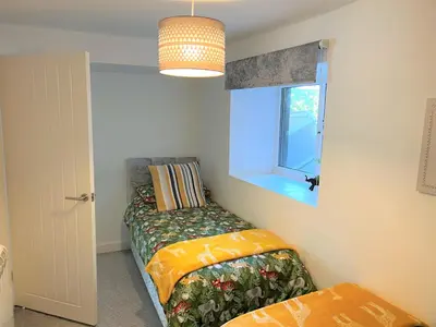 a small bedroom with a bed and a window at Your luxurious and secluded retreat in Cornwall in Helston