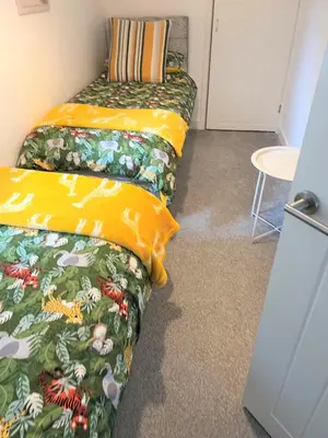 a room with two beds and a table at Your luxurious and secluded retreat in Cornwall in Helston