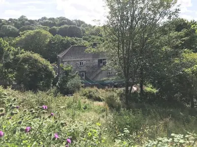 an old stone house in the middle of a field at Your luxurious and secluded retreat in Cornwall in Helston