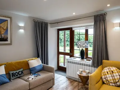 a living room with a couch and a window at The Snug in Wadebridge