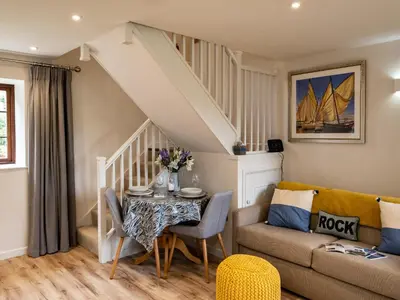 a living room with a table and a couch at The Snug in Wadebridge