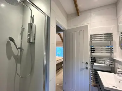a bathroom with a shower and a sink at The Snug in Wadebridge