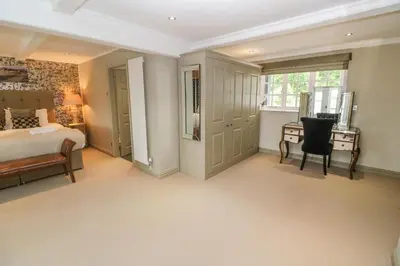 a bedroom with a bed and a desk with a chair at Bodmin Country House in Bodmin