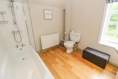 a bathroom with a bath tub and a toilet at Bodmin Country House in Bodmin
