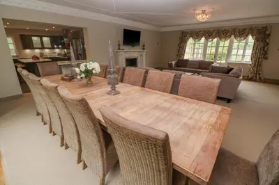 a living room with a wooden table and chairs at Bodmin Country House in Bodmin