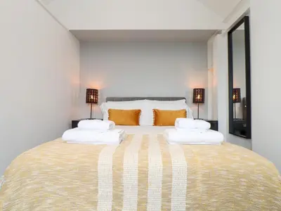 a bedroom with a large bed with two pillows at Three Gables in Newquay