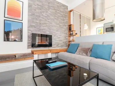 a living room with a couch and a fireplace at Three Gables in Newquay