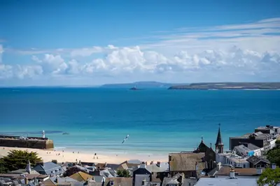 a view of a beach with a town and the ocean at Len's Lookout in St Ives