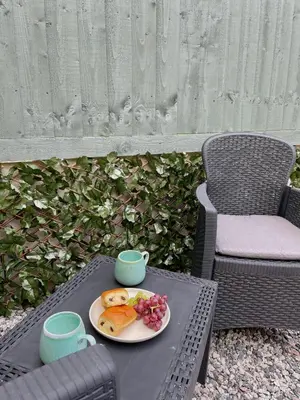 a table with a plate of food and two cups at The Little Hideaway in Truro